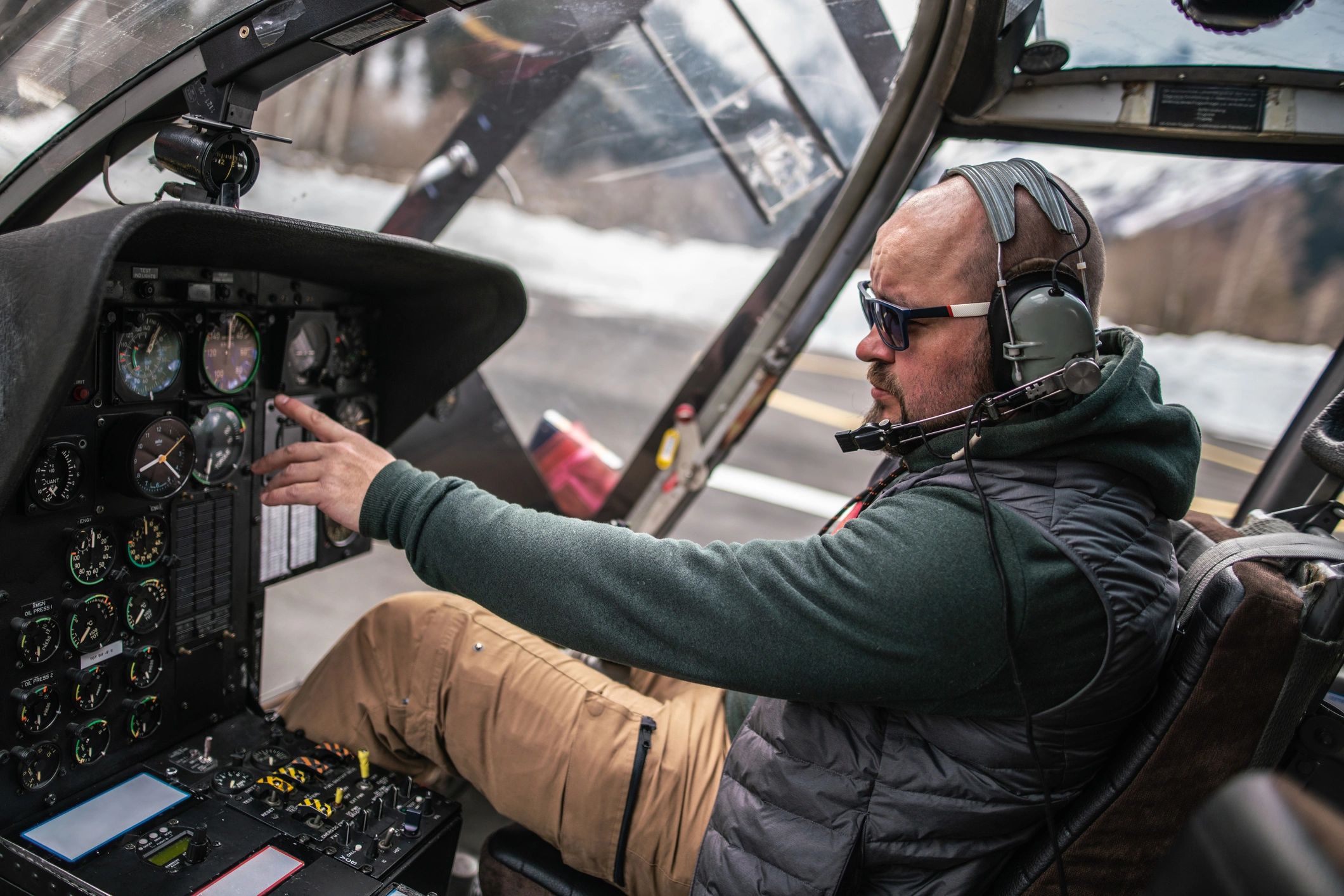 Pilot adjusting aircraft cockpit controls